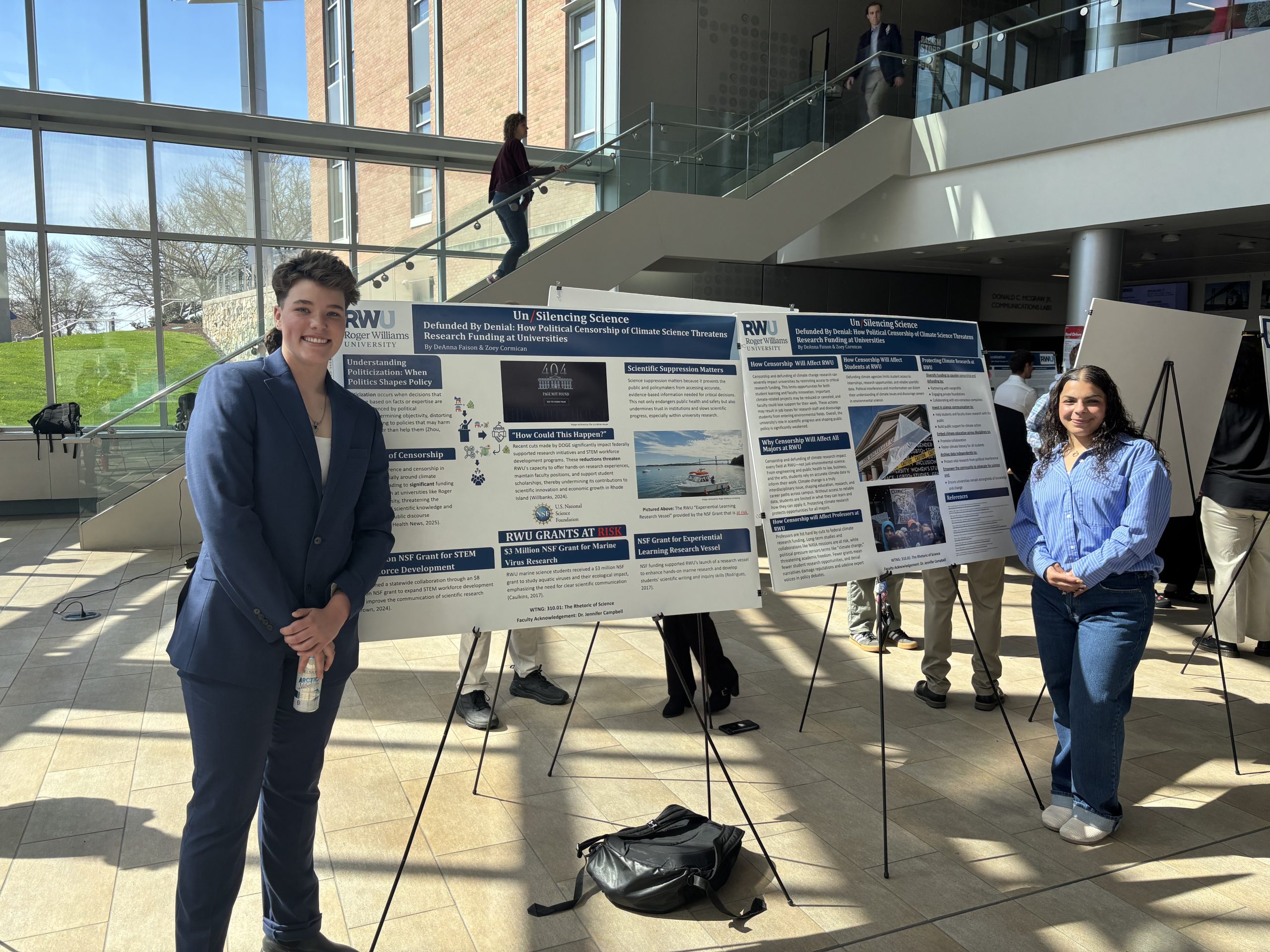 Image of Zoey Cormican and DeAnna Faison next to their posters at SASH