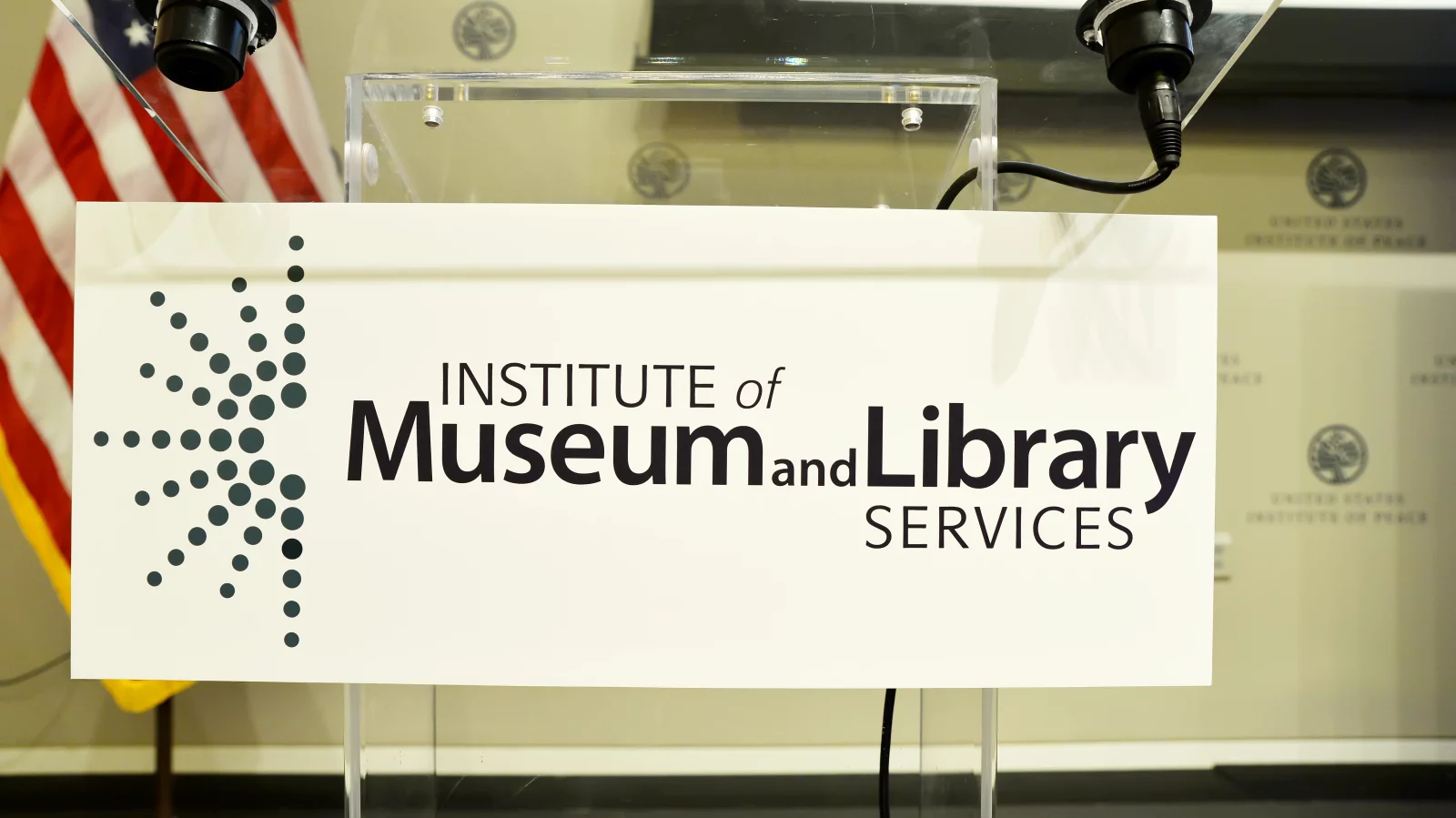 Image of the Institute of Museum and Library Services poster on speaker podium.